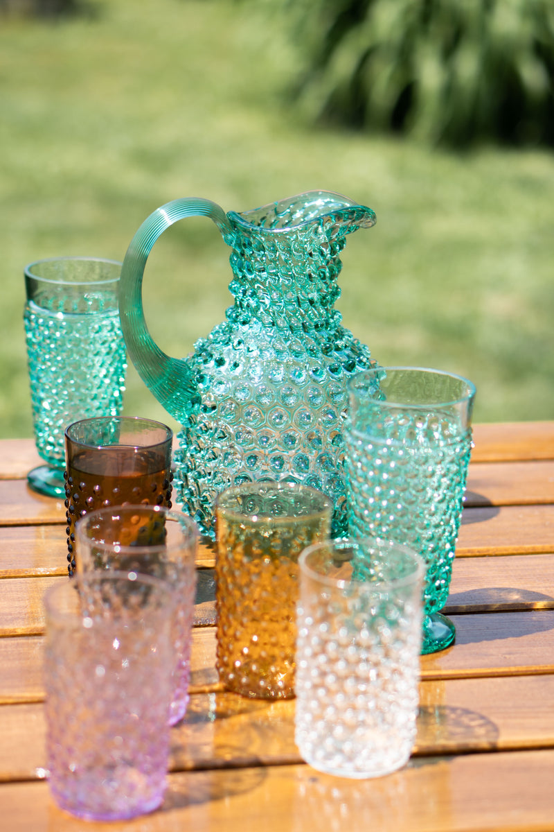 Beryl Glass Square Jug on the table with several Colorful Glasses