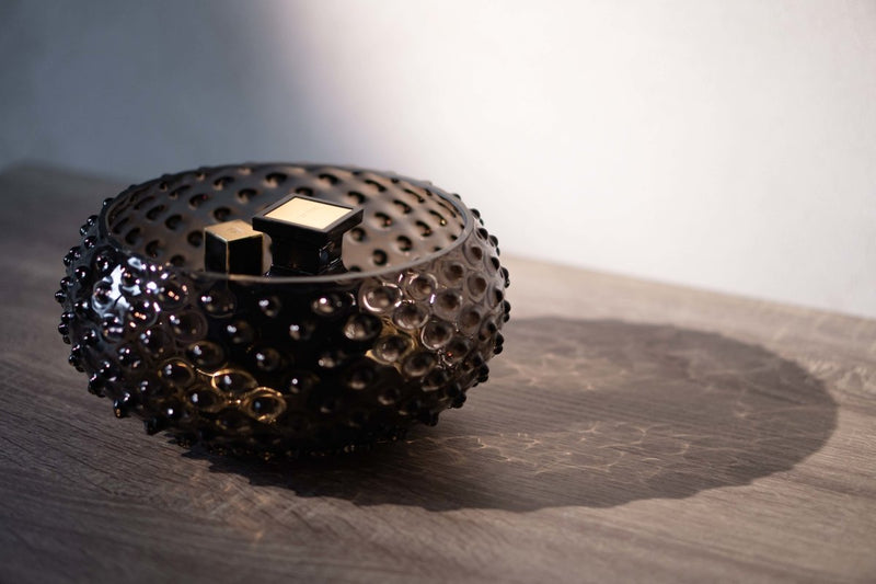 Black smoke hobnail bowl on the wooden table: